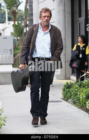 Hugh Laurie carrying his guitar as he arrives at LAX airport on a flight from London Los Angeles, California - 20.07.11 Stock Photo