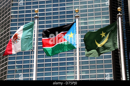 The flag of South Sudan (C) flies outside the United Nations after a flag raising ceremony on the day the General Assembly Stock Photo