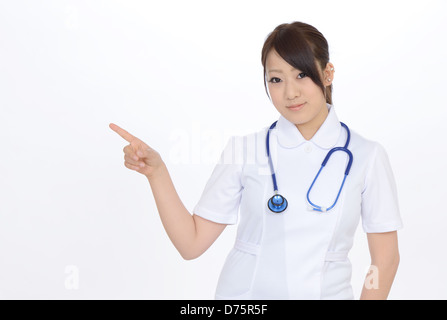 Young asian female nurse pointing Stock Photo