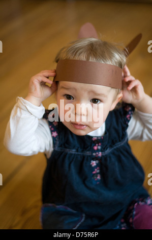 Berlin, Germany, 18 months old girl with rabbit ears Stock Photo