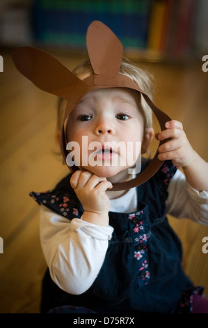 Berlin, Germany, 18 months old girl with rabbit ears Stock Photo