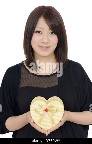 Happy young asian woman holding a gift box Stock Photo