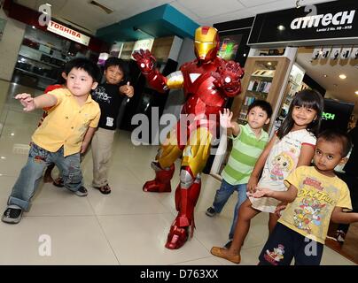 Surabaya, Indonesia. April 28, 2013. A replica of the American super hero, Iron Man, in action to entertain visitors Plaza Marina, gadgets and electronics shopping center in Surabaya. Iron Man 3 is booming in Indonesia, almost in every show, hundreds of spectators specially children lining up to watch the film. (Photo by Robertus Pudyanto/AFLO/Alamy Live News) Stock Photo
