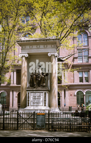 A statue of Peter Cooper, the founder of Cooper Union, sits in front of the college's Foundation Building Stock Photo