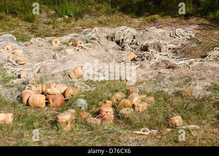 Olf fishnet drying in meadow Stock Photo