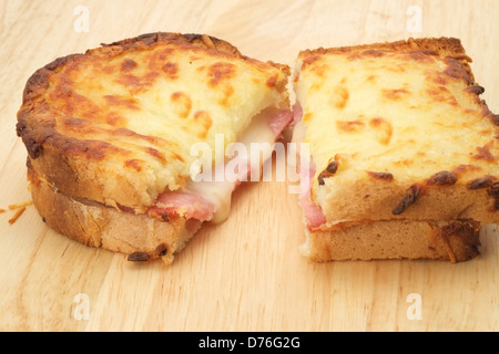 A toasted and cut open Croque Monsieur sandwich with melted cheese and ham Stock Photo