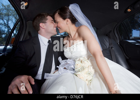 Newlywed Couple In Limousine Stock Photo