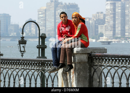 young couple holding hands on the nil river banks, Cairo, Egypt Stock Photo