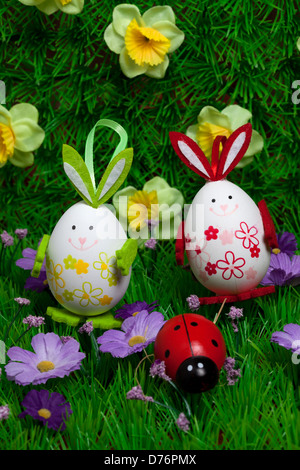 colored eggs in grass with flowers and lillac,Easter, Stock Photo