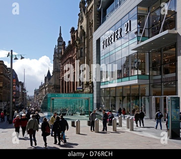 Visitors and shoppers in Buchanan Street Glasgow Scotland with entrance to Glasgow Subway centre. Stock Photo