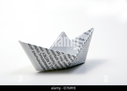 paper boat made of printed paper on light background with copy space around Stock Photo