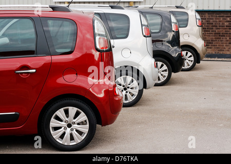 row of new cars for retail sale in a motor dealer yard showing same model in different color choices Stock Photo