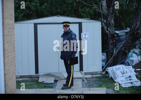 TORONTO, CA., 22 Apr 2013 - A RCMP officer guards a shed at the rear of the home of one of the VIA Rail terrorism plot suspects. RCMP and Toronto Police searched the Cherokee Blvd. home of terrorism suspect Raed Jaser.  Royal Canadian Mounted Police have announced the arrest to two men from Toronto and Montreal that were engaged in an  Al-Qaeda supported plot to derail a VIA Rail passenger train. Stock Photo