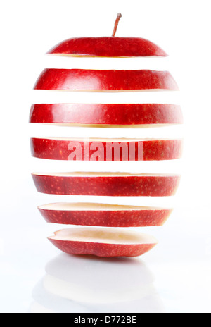 Slices of red apple hanging in mid-air isolated on white background. Food genetical engineering concept. Stock Photo