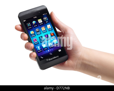 Hand with Blackberry Z10 smartphone isolated on white background Stock Photo