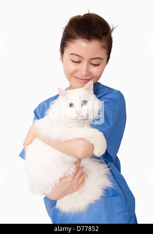 Portrait of female veterinarian holding a white cat Stock Photo