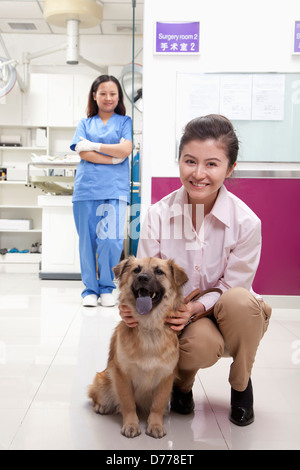 Woman with pet dog in veterinarian's office Stock Photo