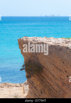 Regatta in Palma Bay in July on azure waters with steep limestone cliff in the foreground. Stock Photo