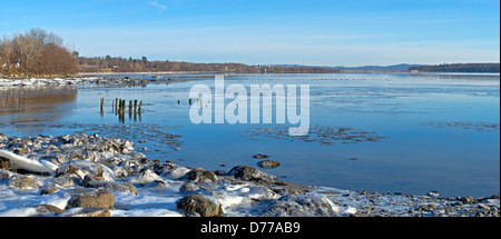 Ice covered rocks on the shore of Stockton Springs Maine in the wintertime. Stock Photo