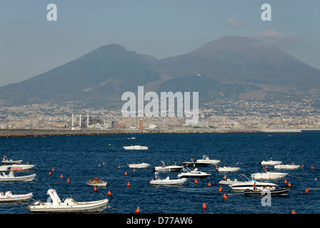 Naples. Italy. View of boats anchored on the Bay of Naples with the unmistakable profile of Mount Vesuvius in the background. Ve Stock Photo