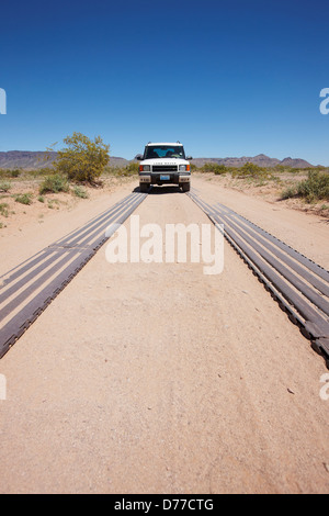 Metal tracks used to reinforce eroding dirt road heavily used by U.S. Border Patrol trucks southern Arizona vehicle on roadway Stock Photo