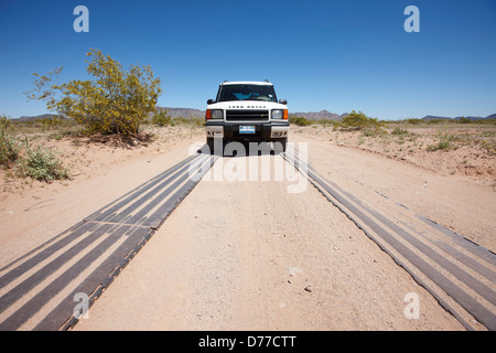 Metal tracks used to reinforce eroding dirt road heavily used by U.S. Border Patrol trucks southern Arizona vehicle on roadway Stock Photo