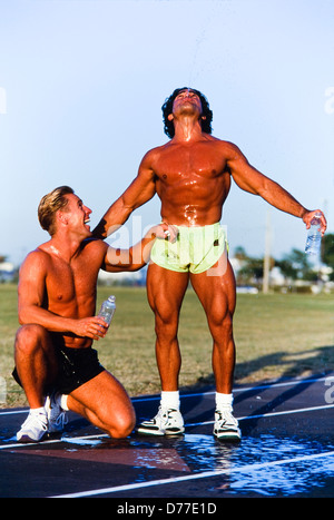 Male athetes hydrating on track, Miami Stock Photo