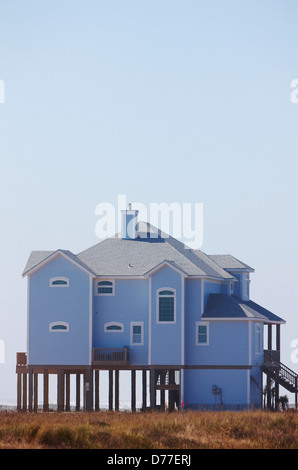 Beach house elevated on pilings protection hurricane storm surge Galveston Island Texas USA Stock Photo
