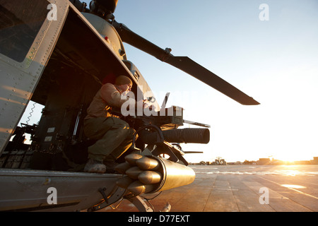 United States Marine gunner aboard UH-1Y Venom helicopter just prior to launching on combat operation in Helmand Province Stock Photo