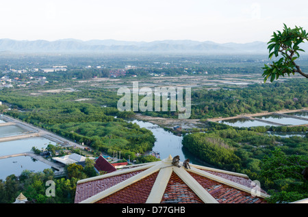 Two macaque monkeys on rooftop of a building at Wat Thammikaram on top of Khao Chong Krajok mountain above Prachuap Khiri Khan Thailand Stock Photo