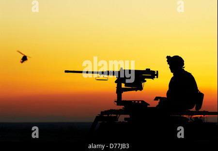 Silhouette US Marine manning M2 .50 caliber machine gun Stock Photo - Alamy