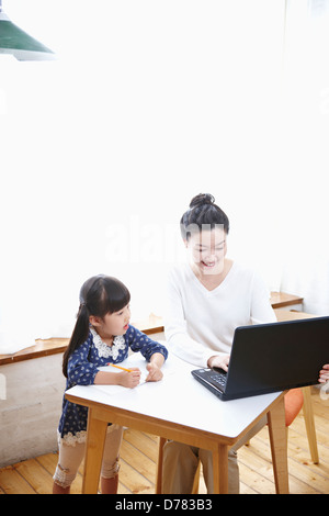mother and daughter using a laptop Stock Photo