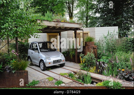 Hampton Court Flowershow 2009 'Rain Chain' garden designed by Wendy Allen incorporating parking for G-Wiz electric car under Stock Photo