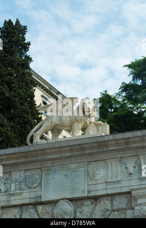 The statue of Venetian Lion up the gate to uphill the castle of Udine Stock Photo