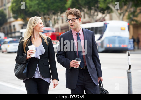 Businessman And Businesswoman In Street With Takeaway Coffee Stock Photo