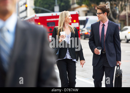 Businessman And Businesswoman In Street With Takeaway Coffee Stock Photo