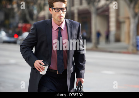 Businessman Hurrying Along Street Holding Takeaway Coffee Stock Photo