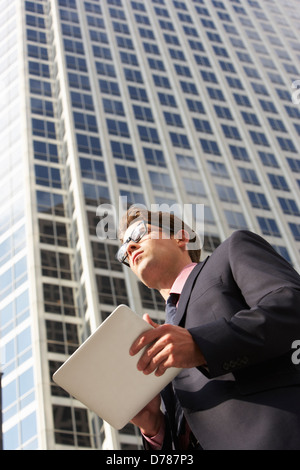 Businessman Working On Tablet Computer Outside Office Stock Photo