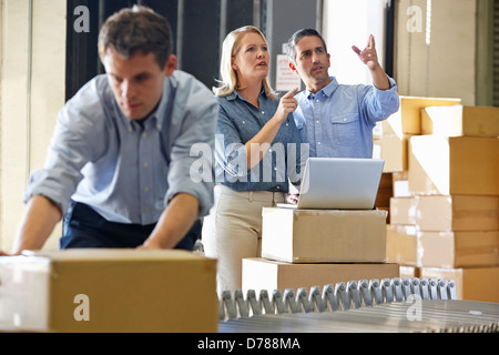 Workers In Distribution Warehouse Stock Photo