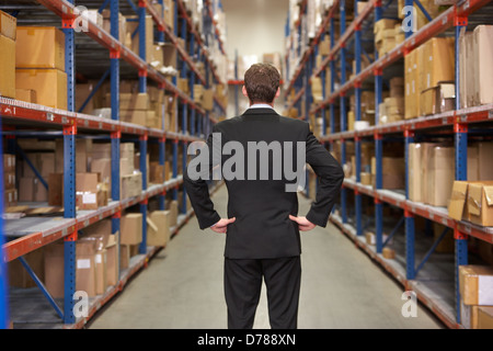 Rear View Of Manager In Warehouse Stock Photo