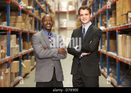 Portrait Of Two Businessmen In Warehouse Stock Photo