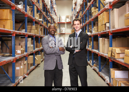 Portrait Of Two Businessmen In Warehouse Stock Photo