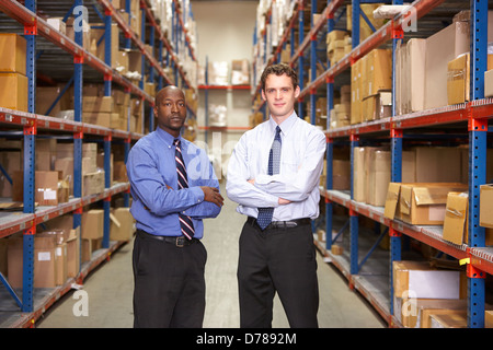 Portrait Of Two Businessmen In Warehouse Stock Photo