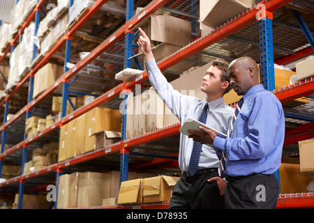 Two Businessmen With Digital Tablet In Warehouse Stock Photo