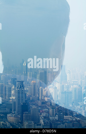 Double exposure of man over cityscape, rear view Stock Photo