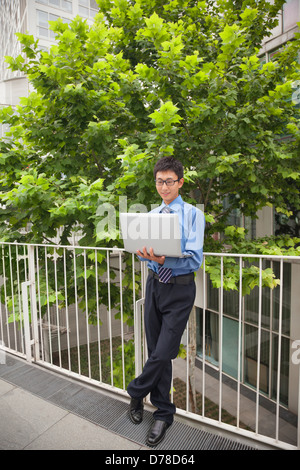 Businessman working outdoors with his laptop Stock Photo