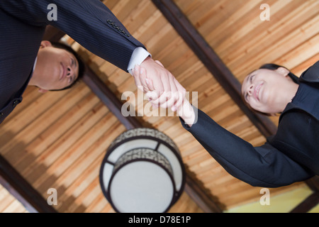 Low Angle View of Businesspeople Shaking Hands Stock Photo