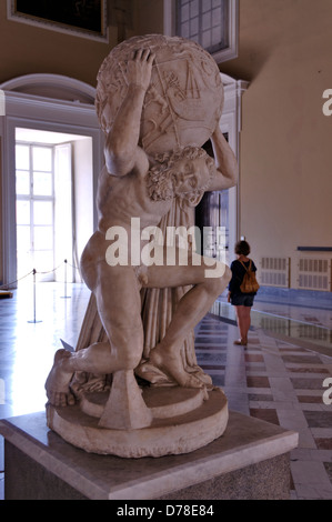 Naples. Italy. Archaeological museum display of the Roman copy of a Hellenistic statue known as the Farnese Atlas or Atlante. Stock Photo
