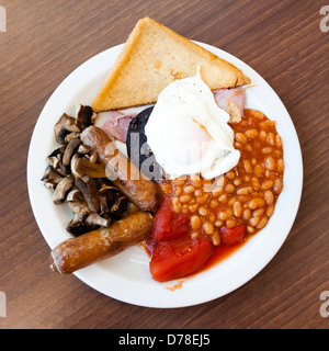 Full English breakfast, with black pudding fry up at a cafe. Fried breakfast overhead food UK. Stock Photo