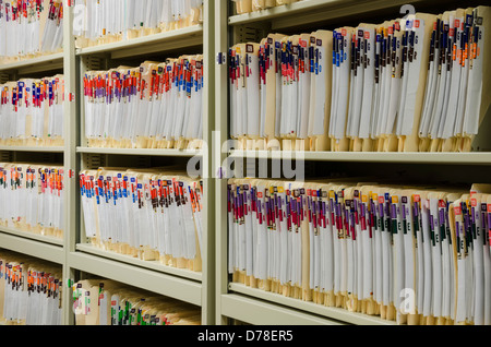 Shelves filled with colorfully labeled medical files Stock Photo